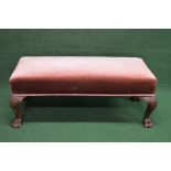 Mahogany foot stool having overstuffed top supported on four carved cabriole legs ending in lions