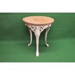 Iron based circular table having wooden top the base being supported by a pierced frieze with