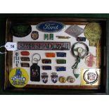 Tray of car motifs, rally plaques and badges, Goodwood Revival steering wheel clock, tie pin etc