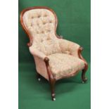 Victorian mahogany framed button back armchair having floral upholstery and standing on cabriole