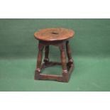 Circular top oak stool the top having cut out and supported on block and turned stretchered legs -