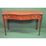 Late 20th century mahogany serving table having cross banded top with serpentine front over three