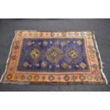 Blue ground rug with yellow, green and red pattern - 1.96m x 1.30m Please note descriptions are
