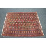 Red ground rug having blue, white and brown pattern - 1.66m x 1.25m Please note descriptions are not