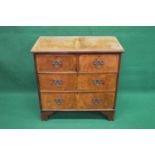Walnut chest of drawers having crossbanded top over two short and two long drawers with brass