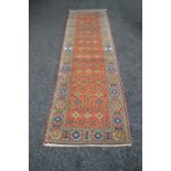 Rust ground carpet runner having cream border with blue, green, red and gold pattern - 2.51m x 0.72m