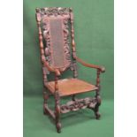 Jacobean high back open armchair having pierced carved back with cane work panel, oval cane work