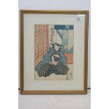 Utagawa Kunisada (1786-1865) a framed Japanese woodblock study of a male figure in an interior