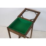 Oak Bijouterie Table, the hinged glazed top opening to a green felt lined interior, 76cms high x