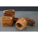 A collection of seven wooden napkin rings to include a mouseman Robert Thompson example.