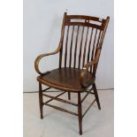 Arts and Crafts Oak Elbow Chair with turned spindle back and bentwood arms, 94cms high x 44cms wide