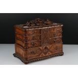 Black Forest style Jewellery Box, the hinged lid carved with flowers and foliage opening to six fold