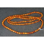 A hand strung amber beaded flapper necklace.