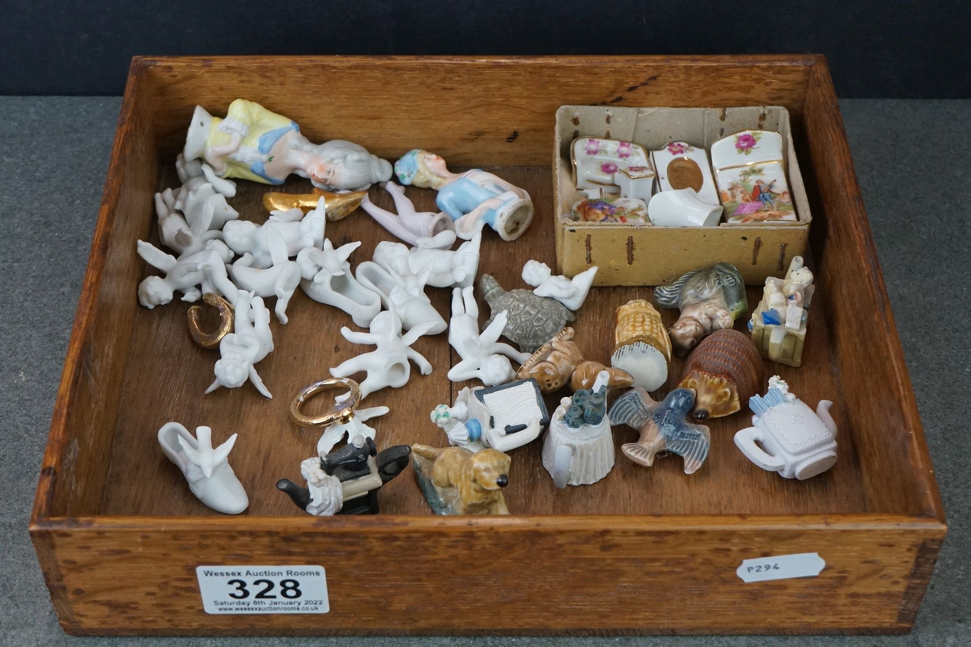 A small collection of ceramics to include ornamental cherubs and Wade animals..etc.