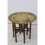 Middle Eastern Brass Circular Tray Top Table raised on a painted folding base, 59cms diameter x