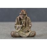 Bronze bearded Buddhist, seated at prayer in the lotus position