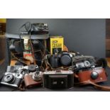 A collection of mixed cameras to include Olympus and Canon examples.