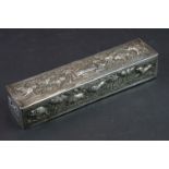 A ornate white metal box with repose decoration of animals including elephants.
