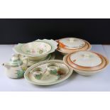 Ten items of Clarice Cliff ceramics including a Grapefruit Bowl, Two Lidded Tureens, Teapot, Milk