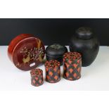 Set of Three Wooden Cylindrical Stacking Boxes decorated with a geometric black and red pattern,