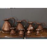 Set of Eight Copper Graduating Measuring Jugs, ranging from 1 Gallon to 1/4 Gill, each with