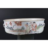 Oriental dish decorated with a figure in a garden, signed with character marks to the edge