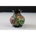 Small Moorcroft Vase decorated with flowers on a black ground, impressed marks to base, 9cms high