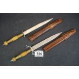 Pair of eastern daggers in leather sheaves