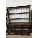 19th century Oak Dresser with open rack above a base with three drawers, shaped apron, turned and