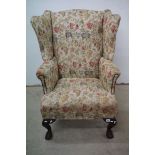 George III style Wingback Armchair with floral upholstery on a cream ground raised on cabriole front