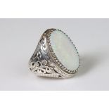 A large white metal and opal dress ring.