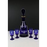 Regency style Blue Glass Decanter with Stopper together with four matching glasses, all with white