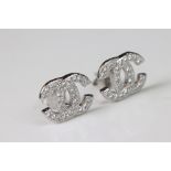Pair of silver and CZ designer style stud earrings