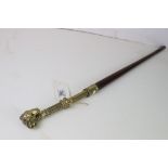 A tampered shaft and brass collared walking stick with rams head handle.
