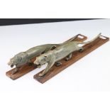 A pair of Art Deco carved horn tigers mounted to wooden bases.