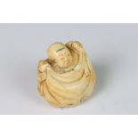 An antique carved ivory netsuke