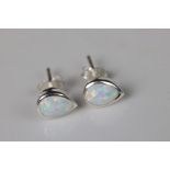 Pair of silver & pear shaped opal stud earrings