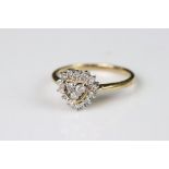 A ladies 9ct gold and Diamond ring, displays 17 brilliant cut diamonds in the form of two