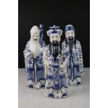 Three Chinese Ceramic Figures of Elders decorated in blue and white, 29cms high