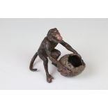 Cold painted bronze figure of a monkey and a large nut