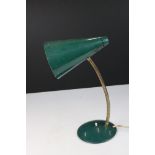 A mid century green adjustable table lamp.