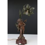 An early 20th century cast lamp in the form of a flower and cherub.