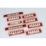 A collection of nine sets of dentistry sample teeth.