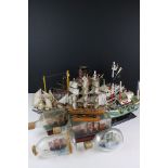 Four Model Ships in Glass Bottles, largest 27cm long together with Three Painted Wooden Models of