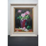 Studio framed still life oil painting, roses in a purple ceramic vase, on a ledge