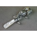 Silver babies rattle in the form of a sea horse with emerald eyes