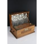 Victorian Oak and Brass Mounted Tantalus holding three matching glass decanters, mirrored back,