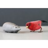 A vintage schuco clockwork mouse together with a clockwork red bird marked made in Germany.