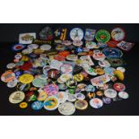 A collection of late 20th century cloth patches and button badges to include advertising examples.