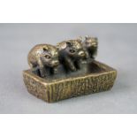 Metal sculpture, a group of three pigs at a trough, length approx. 4.5cm